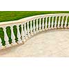 Fancy marble railing on ceramic tile patio with lawn