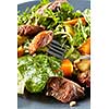 salad with pumpkin and duck meat on a fork