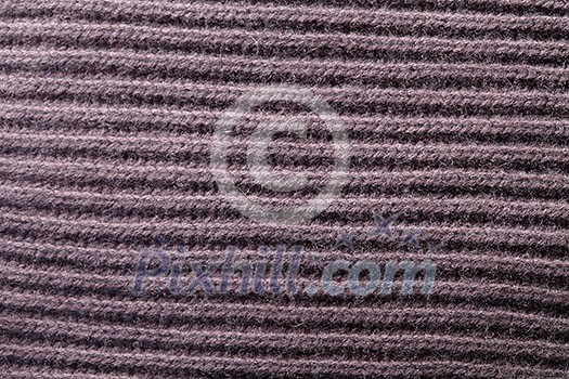texture of soft knitted fabric with a pattern backgrounds of brown color texture of soft knitted fabric with a pattern backgrounds of brown color