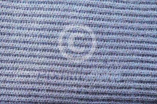 abstract texture of soft knitted fabric with a pattern in the form of a herringbone for backgrounds of gray color abstract texture of soft knitted fabric with a pattern in the form of a herringbone for backgrounds of gray color