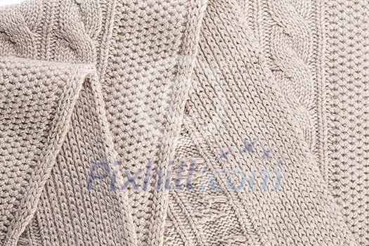 Beige knitted background and texture with factory folds Beige knitted background and texture with factory folds