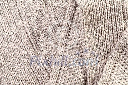 Handmade Beige knitted background and texture with folds Handmade Beige knitted background and texture with folds
