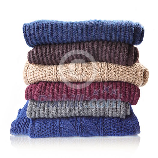 Pile of knitted winter clothes isolated on white, sweaters, knitwear, Pile of knitted winter clothes isolated on white, sweaters, knitwear,