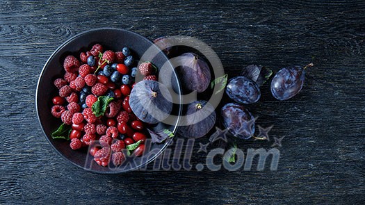 figs and berries on a dark wood background. figs and berries on a dark wood background.