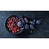 figs and berries on a dark wood background.