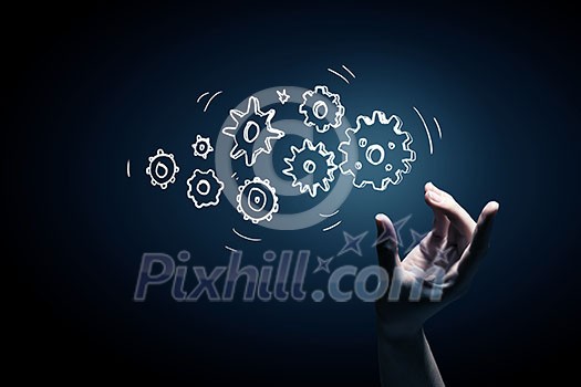 Business person hand touching gear mechanism representing interaction concept Business person hand touching gear mechanism representing interaction concept