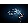 Business person hand touching gear mechanism representing interaction concept
