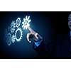 Business person hand touching gear mechanism representing interaction concept