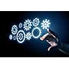 Business person hand touching gear mechanism representing interaction concept