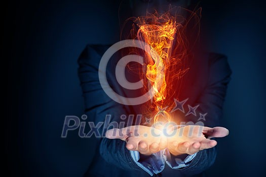 Glowing exclamation mark symbol in palms on dark background Glowing exclamation mark symbol in palms on dark background