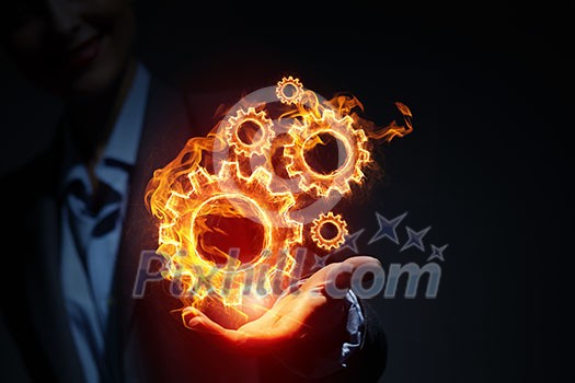 Glowing light setting symbol in palm on dark background Glowing light setting symbol in palm on dark background