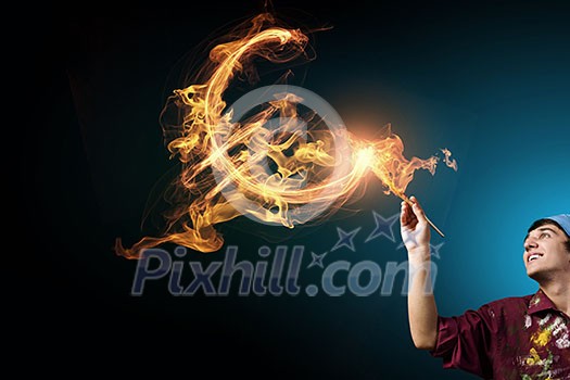 Guy painter drawing dollar sign on dark background Guy painter drawing dollar sign on dark background