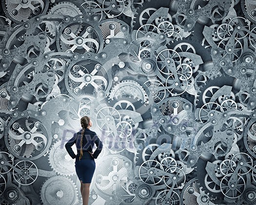 Young businesswoman sitting in chair and looking at gears mechanism Young businesswoman sitting in chair and looking at gears mechanism