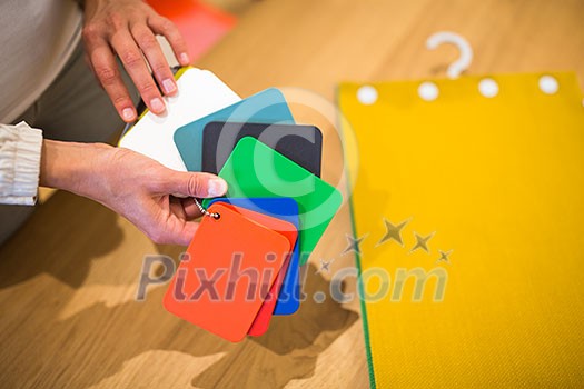 Pretty young woman choosing the right material/color for her modern appartement interior (shallow DOF; color toned image) Pretty young woman choosing the right material/color for her modern appartement interior (shallow DOF; color toned image)