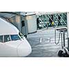 Aircraft with passage corridor/tunnel being prepared for departure from an international airport - Passangers boarding an airplane in a modern airport