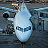 Aircraft with passage corridor/tunnel being prepared for departure from an international airport (color toned image)