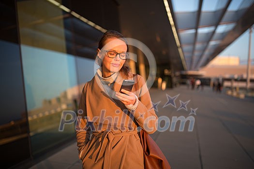 Young female passenger at the airport, using her tablet computer while waiting for her flight (color toned image) Young female passenger at the airport, using her tablet computer while waiting for her flight (color toned image)