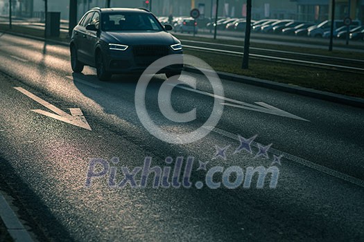 City car traffic - cars on a city road polluting city air with exhaust fumes containing many agents harmful for human health City car traffic - cars on a city road polluting city air with exhaust fumes containing many agents harmful for human health