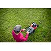 Senior man mowing his garden - shot from above - interesting angle view