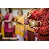Man playing on a tibetian singing bowl (shallow DOF; color toned image)