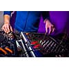 DJ's hands at the music mixer at a party - playing some fine songs for the guests (color toned image)