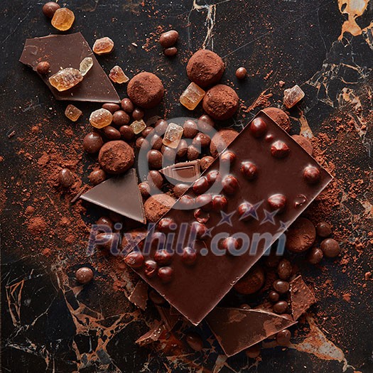 Top view of luxury delicious chocolate and candies truffles in cocoa powder on the marble background Top view of luxury delicious chocolate and candies truffles in cocoa powder on the marble background