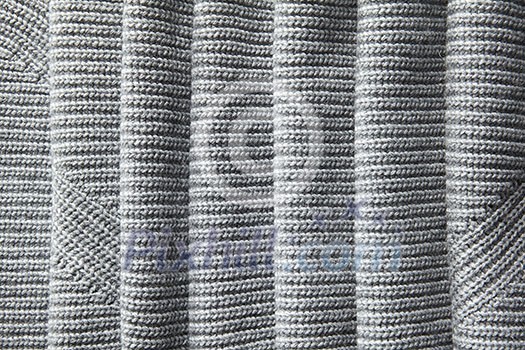 A full page of a loose gray knit fabric texture A full page of a loose gray knit fabric texture