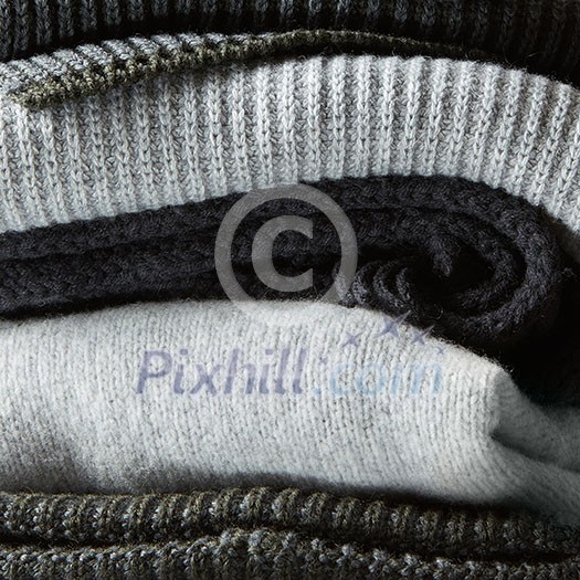 Pile of knitted winter clothes on background, sweaters, knitwear, Pile of knitted winter clothes on background, sweaters, knitwear,