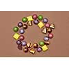 frame of chocolates on a brown background.