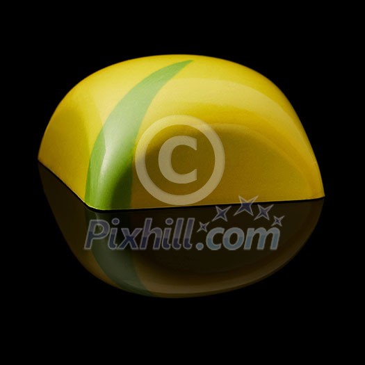 Sideways yellow chocolate candy on a black background Sideways yellow chocolate candy on a black background