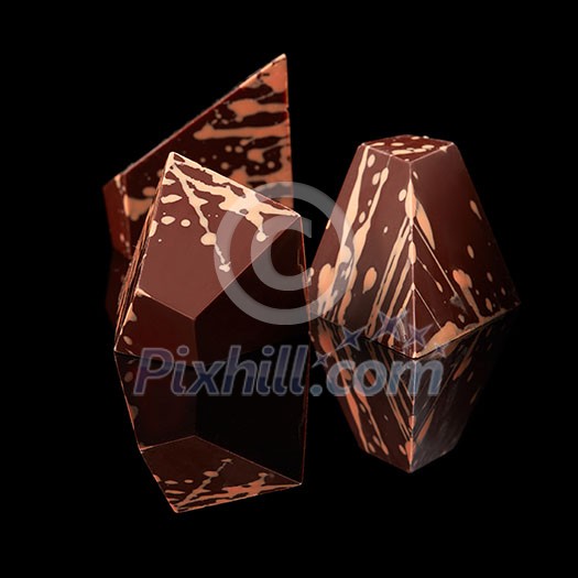 three arched chocolates isolated on a black background three arched chocolates isolated on a black background