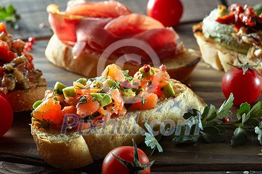 Bruschetta set . Black wood background, top view, horizontal composition Bruschetta set . Black wood background, top view, horizontal composition