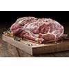 Photo of raw meat. Pork neck with herbs and green thyme on wooden board