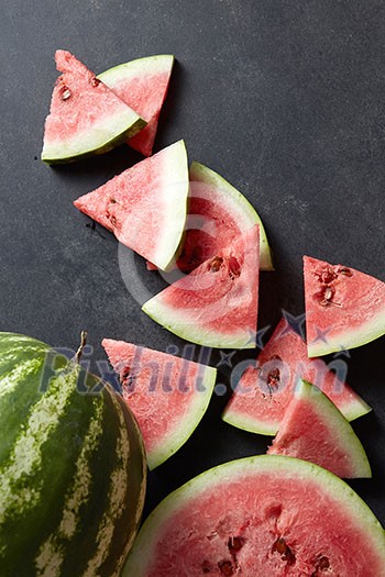 fresh watermelon and slices on a black table fresh watermelon and slices on a black table