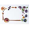 Plums and wooden spoons on a white background