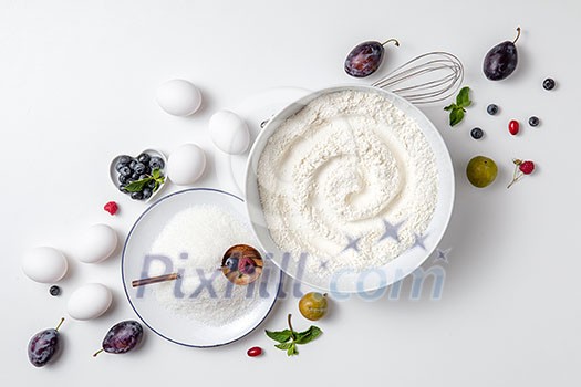 Making dough for berry pie. Ingredients for berry pie on a white background Making dough for berry pie. Ingredients for berry pie on a white background