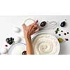 Raw ingredients for baking pie with berries. Woman hand take bowl with sugar on a white background