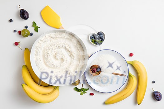 the ingredients for the banana cake with plums on white background the ingredients for the banana cake with plums on white background