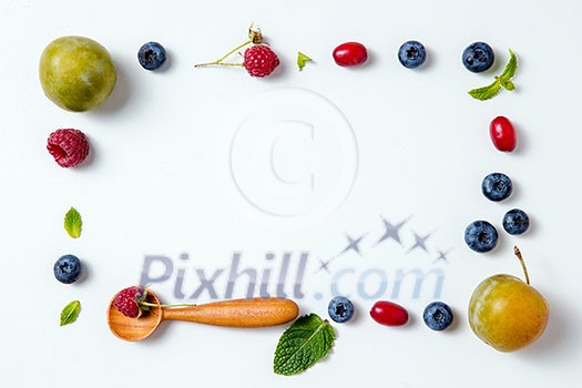 Autumn berries and wooden spoons on a white background. Horizontal photo Autumn berries and wooden spoons on a white background. Horizontal photo