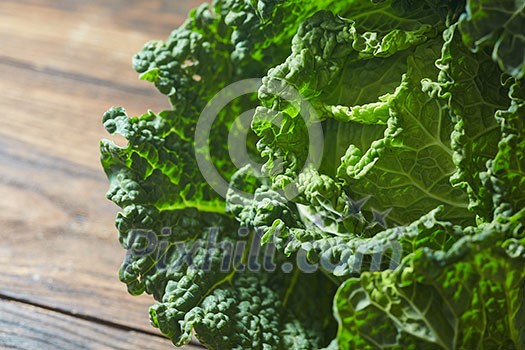 Savoy cabbage super food close up in wooden background Savoy cabbage super food close up in wooden background