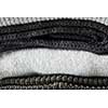 Stack of grey knitted clothes close up