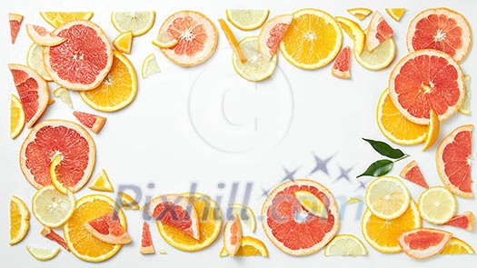 citrus fruit frame of citrus slices isolated on white background as a symbol of healthy eating and immune system boost with natural vitamins. citrus fruit frame of citrus slices isolated on white background as a symbol of healthy eating and immune system boost with natural vitamins.