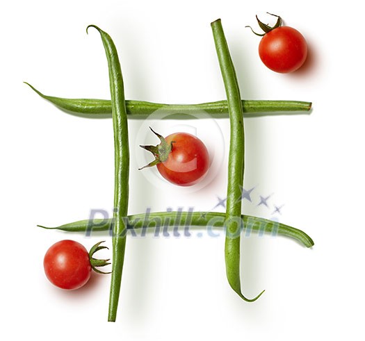 Food game Tic-tac-toe. diet beans and cherry tomatoes on a white background Food game Tic-tac-toe. diet beans and cherry tomatoes on a white background