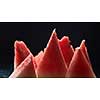 slices of ripe juicy watermelon isolated on black background