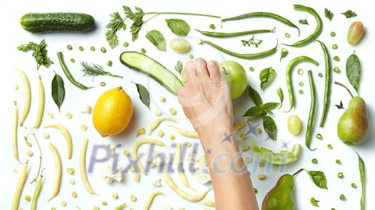 Close up of green vegetables and fruits on white background. Healthy eating and food for vegans. Behind the scenes Close up of green vegetables and fruits on white background. Healthy eating and food for vegans. Behind the scenes
