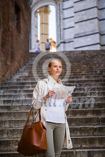 Gorgeous female tourist with a map discovering a foreign city (shallow DOF; color toned image) Gorgeous female tourist with a map discovering a foreign city (shallow DOF; color toned image)