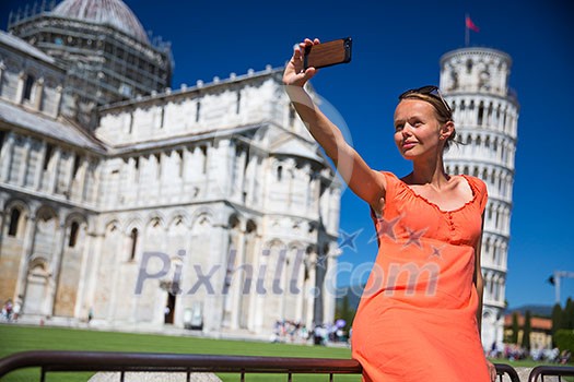 Gorgeous young woman taking a selfie with her smart phone in front of the Leaning Tower of Pisa, Tuscany, Italy (shallow DOF) Gorgeous young woman taking a selfie with her smart phone in front of the Leaning Tower of Pisa, Tuscany, Italy (shallow DOF)