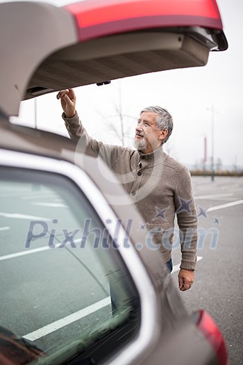 Senior drive driving his modern car, going in reverse, watching out not to hit anything or anyone (color toned image; shallow DOF) Senior drive driving his modern car, going in reverse, watching out not to hit anything or anyone (color toned image; shallow DOF)