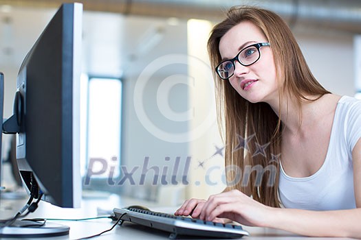 Pretty, female student looking at a desktop computer screen, learning unpleasant news about her exam results. University/office/school concept Pretty, female student looking at a desktop computer screen, learning unpleasant news about her exam results. University/office/school concept
