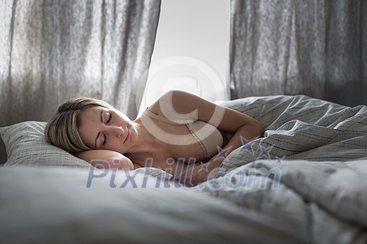 Beautiful young woman sleeping in bed
